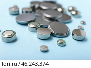 Lithium button cell batteries on blue background, closeup. Стоковое фото, фотограф Pixel_shot / Фотобанк Лори