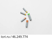 Alkaline batteries on white background, top view. Стоковое фото, фотограф Pixel_shot / Фотобанк Лори