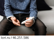 Diabetic child taking blood sample with lancet pen at home. Стоковое фото, фотограф Pixel_shot / Фотобанк Лори