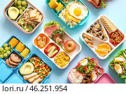 Many lunchboxes with different delicious food on blue background. Стоковое фото, фотограф Pixel_shot / Фотобанк Лори
