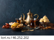 Tasty Eastern sweets and tea on dark background. Стоковое фото, фотограф Pixel_shot / Фотобанк Лори