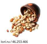 Overturned bowl with scattered nuts on white background. Стоковое фото, фотограф Pixel_shot / Фотобанк Лори