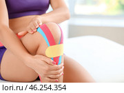 Sporty woman with physio tape applied on knee, closeup. Стоковое фото, фотограф Pixel_shot / Фотобанк Лори