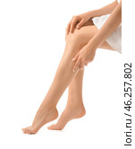 Young woman showing silky skin on legs after epilation against white background. Стоковое фото, фотограф Pixel_shot / Фотобанк Лори