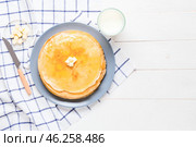 Tasty blini with butter and milk on table. Стоковое фото, фотограф Pixel_shot / Фотобанк Лори