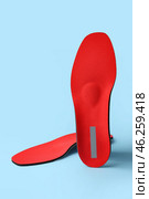 Orthopedic insoles on blue background. Стоковое фото, фотограф Pixel_shot / Фотобанк Лори
