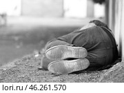Black and white photo of poor homeless man sleeping on ground outdoors. Стоковое фото, фотограф Pixel_shot / Фотобанк Лори