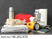 Necessities for emergency bag on dark table. Стоковое фото, фотограф Pixel_shot / Фотобанк Лори