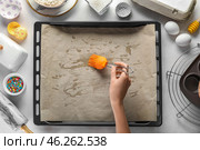 Woman greasing parchment paper with oil on white background. Стоковое фото, фотограф Pixel_shot / Фотобанк Лори
