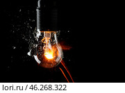 Breaking of light bulb on dark background. Стоковое фото, фотограф Pixel_shot / Фотобанк Лори