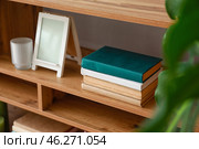 Shelving unit with books in interior of room. Стоковое фото, фотограф Pixel_shot / Фотобанк Лори