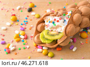 Delicious sweet bubble waffle on wooden board. Стоковое фото, фотограф Pixel_shot / Фотобанк Лори