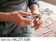 Jeweller examining adornment in workshop, closeup. Стоковое фото, фотограф Pixel_shot / Фотобанк Лори