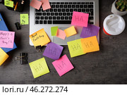 Laptop with stationery and sticky notes on grey background. April Fool's Day prank. Стоковое фото, фотограф Pixel_shot / Фотобанк Лори