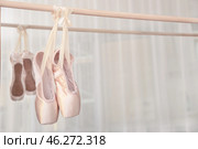 Ballet shoes hanging on bar in studio. Стоковое фото, фотограф Pixel_shot / Фотобанк Лори