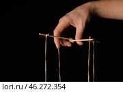 Hand of puppeteer on dark background. Стоковое фото, фотограф Pixel_shot / Фотобанк Лори