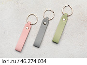 Leather keychains on light background. Стоковое фото, фотограф Pixel_shot / Фотобанк Лори