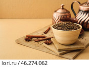 Board with dry hojicha green tea, teapot and cup of hot beverage on color background. Стоковое фото, фотограф Pixel_shot / Фотобанк Лори