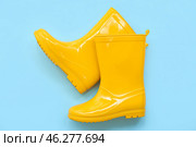 Yellow gumboots on blue background. Стоковое фото, фотограф Pixel_shot / Фотобанк Лори
