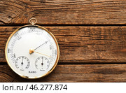 Aneroid barometer on brown wooden background. Стоковое фото, фотограф Pixel_shot / Фотобанк Лори