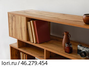 Shelving unit with books and decor in interior of room. Стоковое фото, фотограф Pixel_shot / Фотобанк Лори