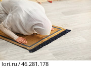 Young Muslim woman praying at home. Стоковое фото, фотограф Pixel_shot / Фотобанк Лори