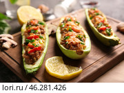 Meat stuffed zucchini boats on board, closeup. Стоковое фото, фотограф Pixel_shot / Фотобанк Лори