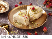 Plate with pieces of tasty Tahini halva on grunge background. Стоковое фото, фотограф Pixel_shot / Фотобанк Лори