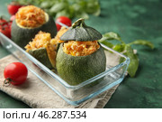 Dish with quinoa stuffed zucchinis on green table, closeup. Стоковое фото, фотограф Pixel_shot / Фотобанк Лори