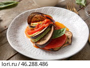 Plate of tasty Ratatouille on wooden background. Стоковое фото, фотограф Pixel_shot / Фотобанк Лори