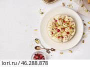 Plate of tasty Tahini halva with pistachios on light background. Стоковое фото, фотограф Pixel_shot / Фотобанк Лори