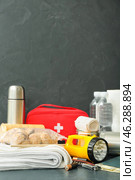 Necessities for emergency bag on dark table. Стоковое фото, фотограф Pixel_shot / Фотобанк Лори