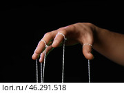 Hand of puppeteer on dark background. Стоковое фото, фотограф Pixel_shot / Фотобанк Лори
