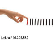Female hand pushing dominoes on white background. Стоковое фото, фотограф Pixel_shot / Фотобанк Лори
