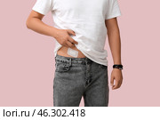 Young man with medical patch after appendix surgery on pink background, closeup. Стоковое фото, фотограф Pixel_shot / Фотобанк Лори