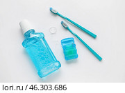 Dental floss with tooth brushes and rinse on white background. Стоковое фото, фотограф Pixel_shot / Фотобанк Лори