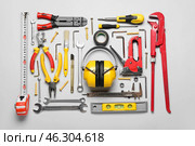 Hearing protectors with builder's tools on grey background. Стоковое фото, фотограф Pixel_shot / Фотобанк Лори