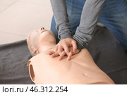 Man learning to perform CPR at first aid training course. Стоковое фото, фотограф Pixel_shot / Фотобанк Лори