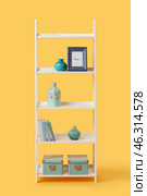 Shelving unit with decor on color background. Стоковое фото, фотограф Pixel_shot / Фотобанк Лори