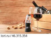Wine aerator with bottles and glasses on wooden background. Стоковое фото, фотограф Pixel_shot / Фотобанк Лори