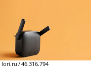Black WiFi repeater on orange background. Стоковое фото, фотограф Pixel_shot / Фотобанк Лори