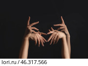 Stroboscopic photo of moving female hands on dark background. Стоковое фото, фотограф Pixel_shot / Фотобанк Лори
