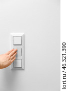 Woman switching on light at home, closeup. Стоковое фото, фотограф Pixel_shot / Фотобанк Лори