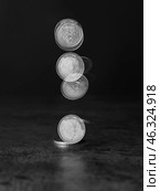Stroboscopic photo of falling coin on dark background. Стоковое фото, фотограф Pixel_shot / Фотобанк Лори