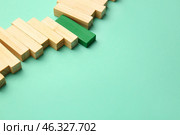Green block among wooden ones on color background. Concept of uniqueness. Стоковое фото, фотограф Pixel_shot / Фотобанк Лори