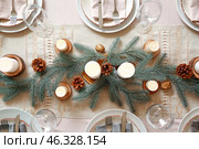 Beautiful table setting with Christmas decorations in living room. Стоковое фото, фотограф Pixel_shot / Фотобанк Лори