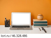 Stylish workplace with laptop near color wall. Стоковое фото, фотограф Pixel_shot / Фотобанк Лори