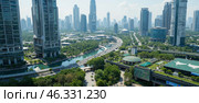 Urban landscape with high-rise buildings, green parks, winding streets, and river flowing through city, demonstrating mix of nature and modern infrastructure in metropolitan area. Стоковое AI-изображение, AI-художник Павел Муравьев / Фотобанк Лори