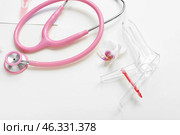 Gynecological speculum and stethoscope on white background. Стоковое фото, фотограф Pixel_shot / Фотобанк Лори