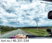 Driving on a winter road with cracked windshield and poor visibility in cold weather conditions. Стоковое фото, фотограф Кривошеина Елена Леонидовна / Фотобанк Лори